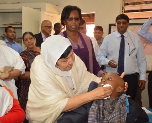 Acharyashri Attending to a Child with CP